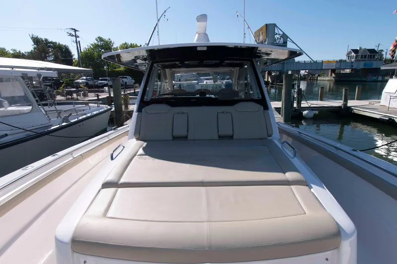 Slide: The Image of 2019 Pursuit S 408 Sport boat docked, featuring spacious deck and sleek design. - 21