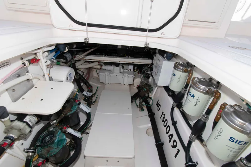 Slide: The Image of Engine compartment of a 2019 Pursuit S 408 Sport boat, showcasing mechanical components. - 29