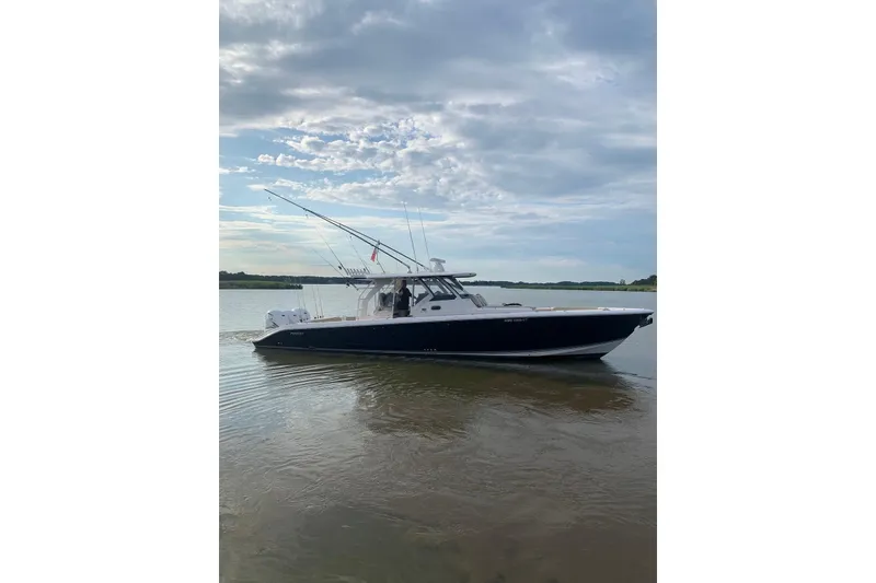 Slide: The Image of 2019 Pursuit S 408 Sport boat on calm water under cloudy sky. - 3