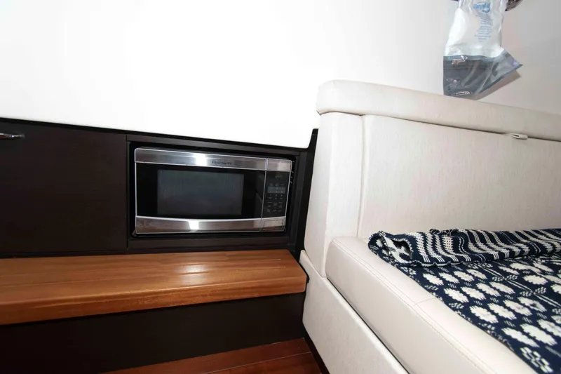 Slide: The Image of 2019 Pursuit S 408 Sport interior with microwave and seating area. - 32