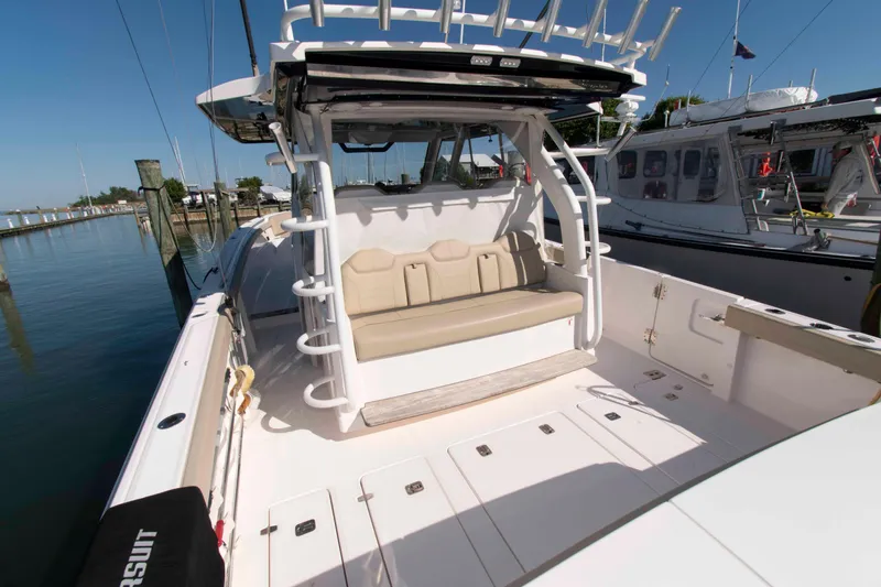 Slide: The Image of 2019 Pursuit S 408 Sport boat interior with seating, docked at marina. - 5