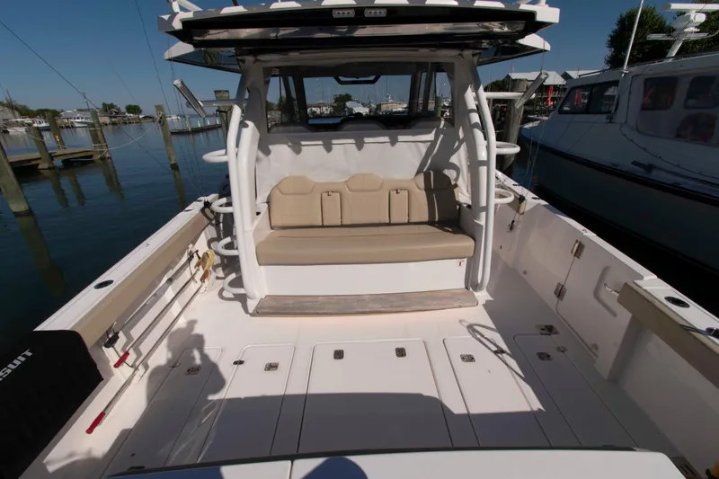 Slide: The Image of 2019 Pursuit S 408 Sport boat interior with seating and fishing rod holders. - 6