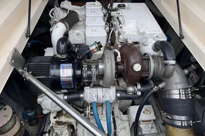 Slide: The Image of Engine compartment of a 2001 Mainship Pilot 30 boat, showcasing mechanical components. - 13