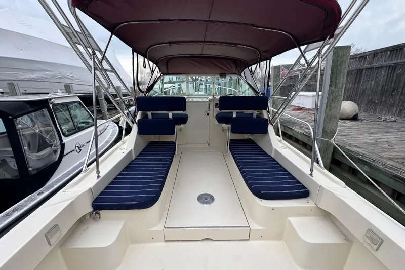 Slide: The Image of 2001 Mainship Pilot 30 boat interior with striped seating and canopy. - 5