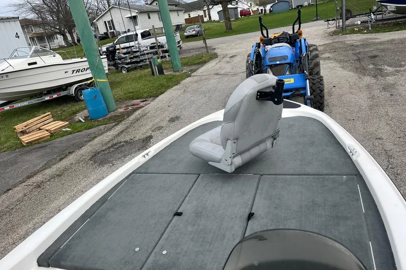 Slide: The Image of 2008 Stratos 176 XT boat with a tractor in a yard setting. - 10
