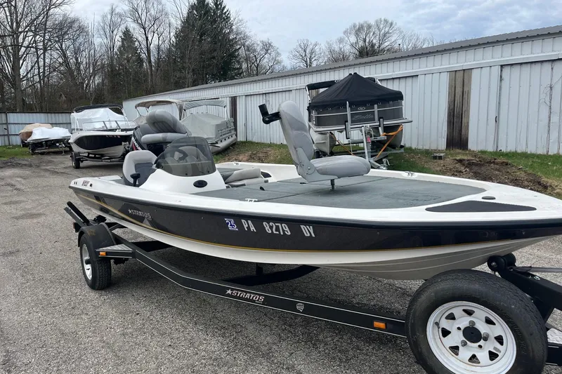 Slide: The Image of 2008 Stratos 176 XT boat on trailer, parked outdoors near other boats. - 5