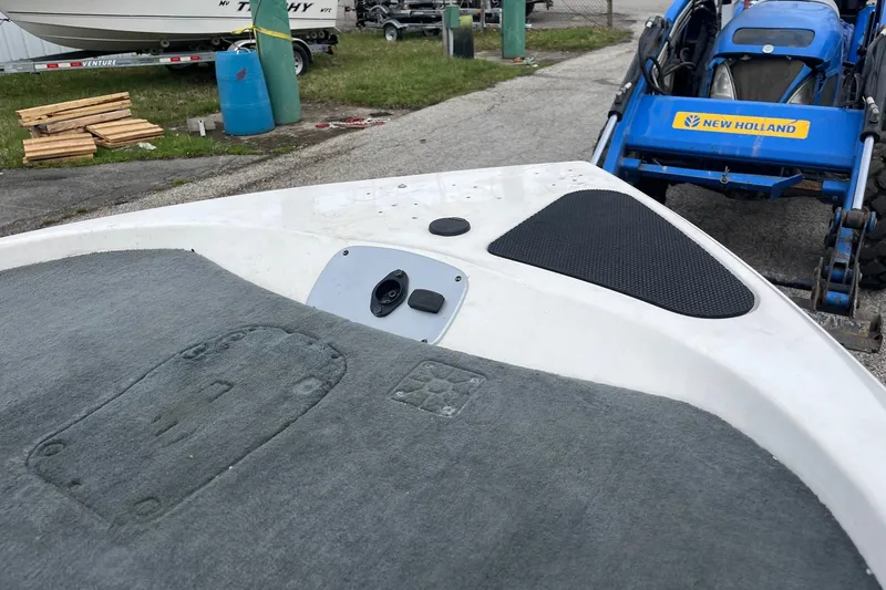 Slide: The Image of 2008 Stratos 176 XT boat deck with carpet, near New Holland tractor. - 6