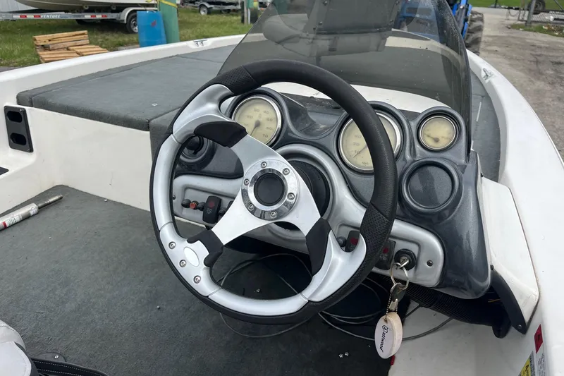 Slide: The Image of Steering wheel and dashboard of a 2008 Stratos 176 XT boat. - 8