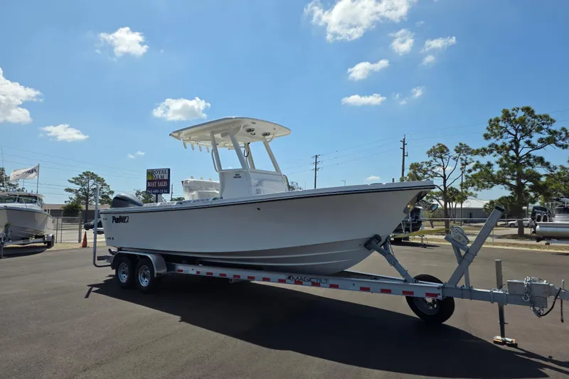 The Image of 2026 Parker 254 FATHOM boat on trailer at dealership under clear blue sky. - 1
