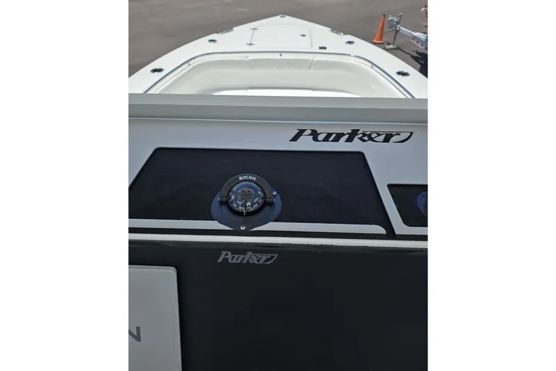 Slide: The Image of 2026 Parker 254 FATHOM boat dashboard with compass and logo. - 10