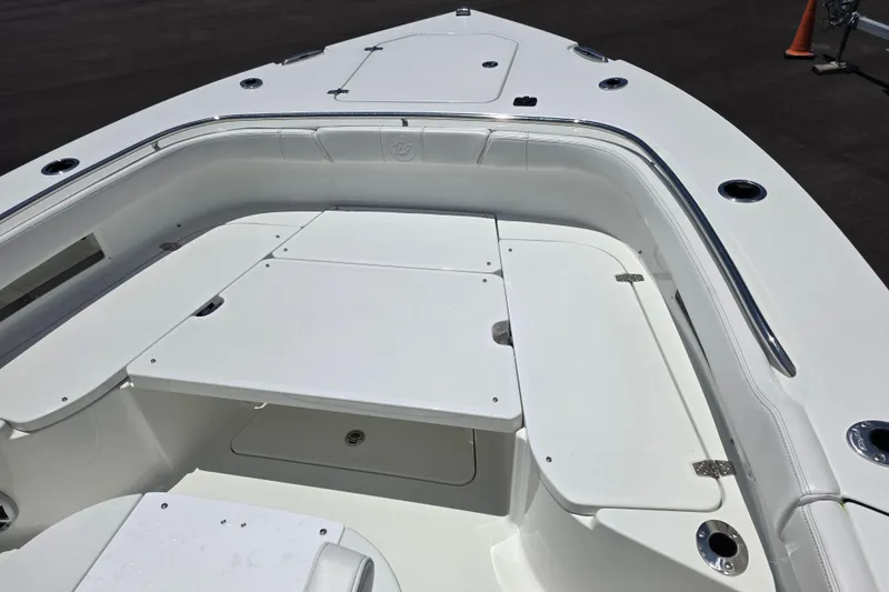 Slide: The Image of 2026 Parker 254 FATHOM boat interior with sleek white seating and storage compartments. - 11