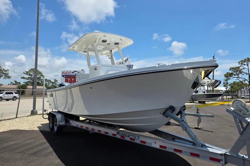 Slide: The Image of 2026 Parker 254 FATHOM boat on trailer under clear blue sky. - 3