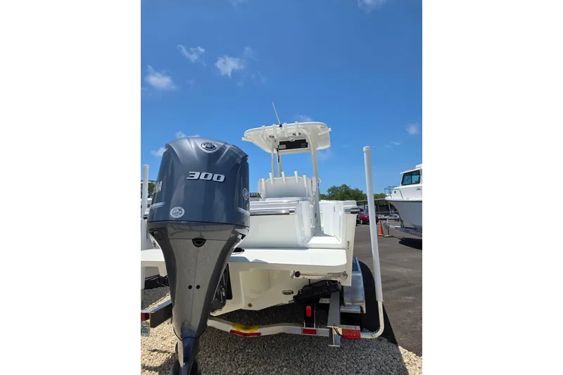 Slide: The Image of 2026 Parker 254 FATHOM boat with Yamaha 300 engine, parked outdoors under clear blue sky. - 4