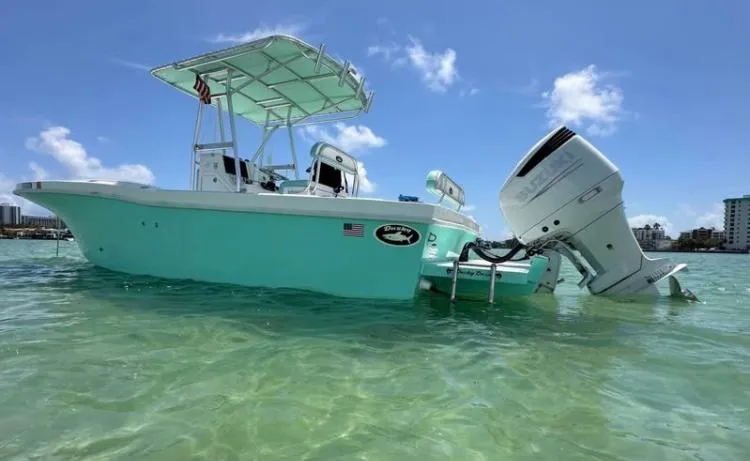 The Image of 2023 Dusky 252 boat in clear water, featuring a powerful outboard motor. - 1