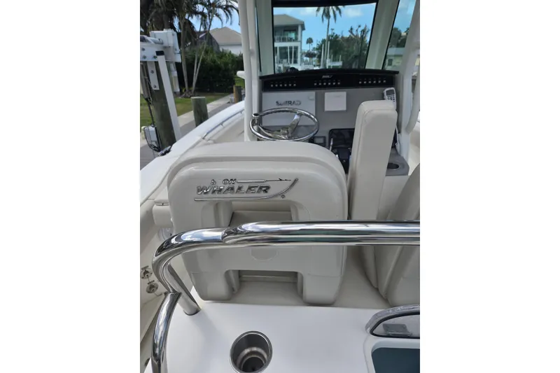 Slide: The Image of 2017 Boston Whaler 250 Outrage boat interior with steering wheel and seating. - 10