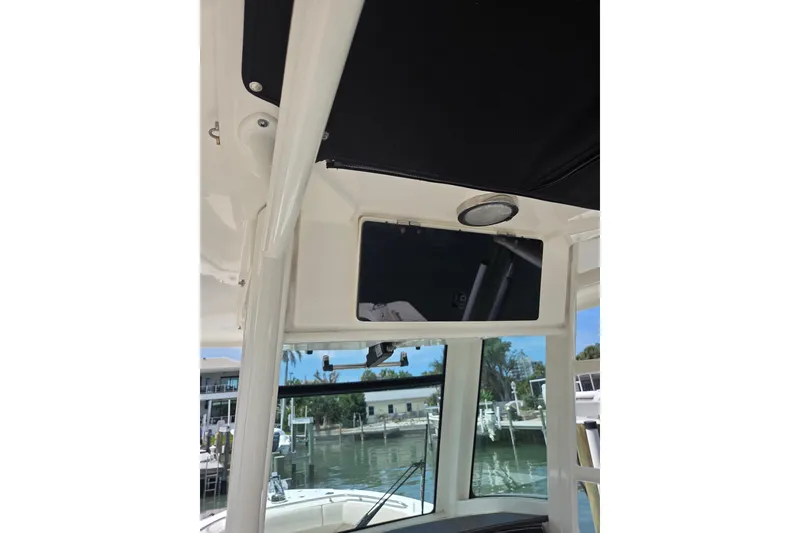 Slide: The Image of 2017 Boston Whaler 250 Outrage boat interior with overhead compartment and window view. - 12