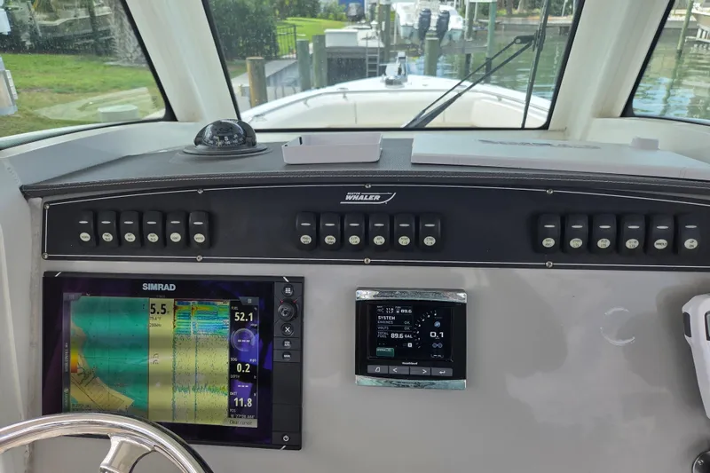 Slide: The Image of 2017 Boston Whaler 250 Outrage dashboard with navigation and control systems. - 18