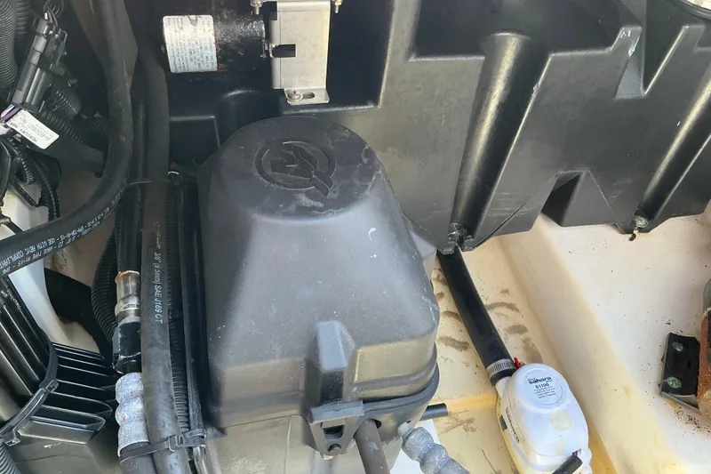 Slide: The Image of Engine compartment of a 2017 Boston Whaler 250 Outrage boat, showing hoses and components. - 25