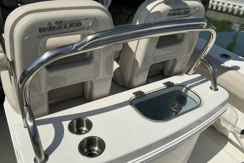 Slide: The Image of 2017 Boston Whaler 250 Outrage boat interior with seating and stainless steel railings. - 27