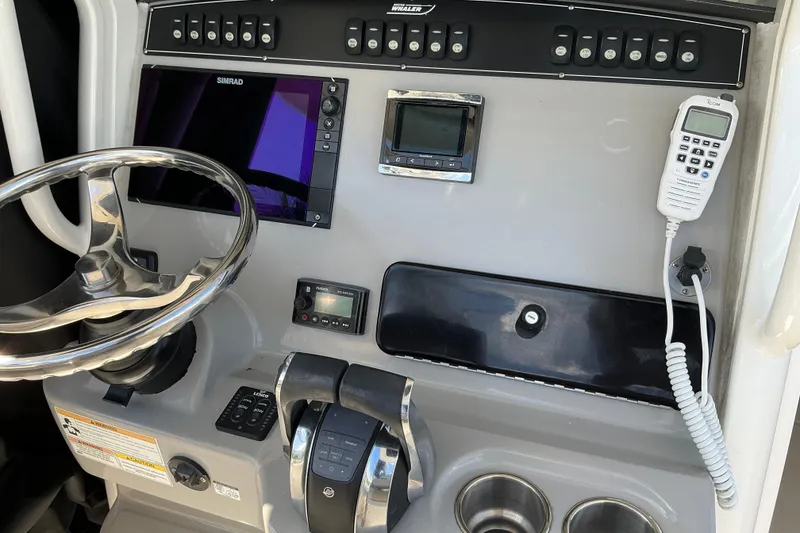 Slide: The Image of Control panel of a 2017 Boston Whaler 250 Outrage boat with steering wheel and electronics. - 28