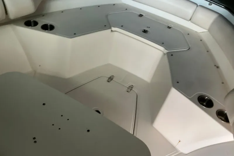 Slide: The Image of Interior view of 2017 Boston Whaler 250 Outrage boat, featuring seating and storage compartments. - 30