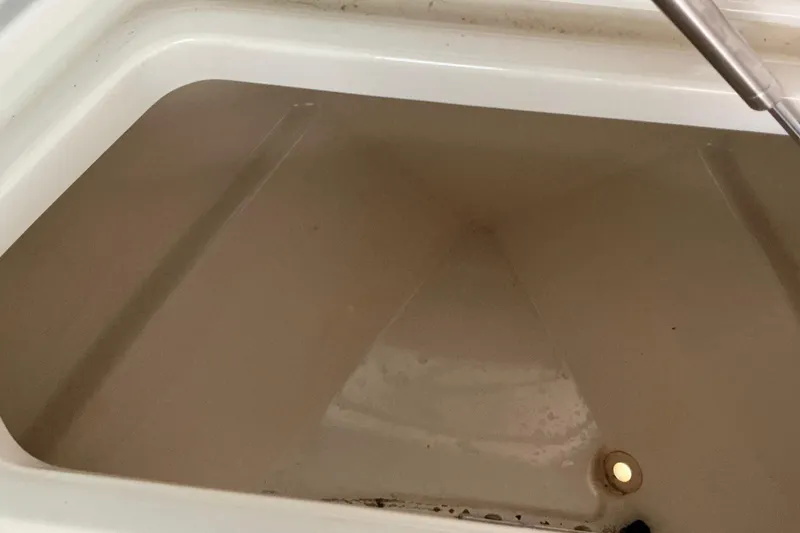 Slide: The Image of Livewell interior of 2017 Boston Whaler 250 Outrage boat, partially filled with water. - 33