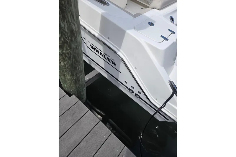 Slide: The Image of Boston Whaler 250 Outrage 2017 boat docked at a wooden pier. - 4