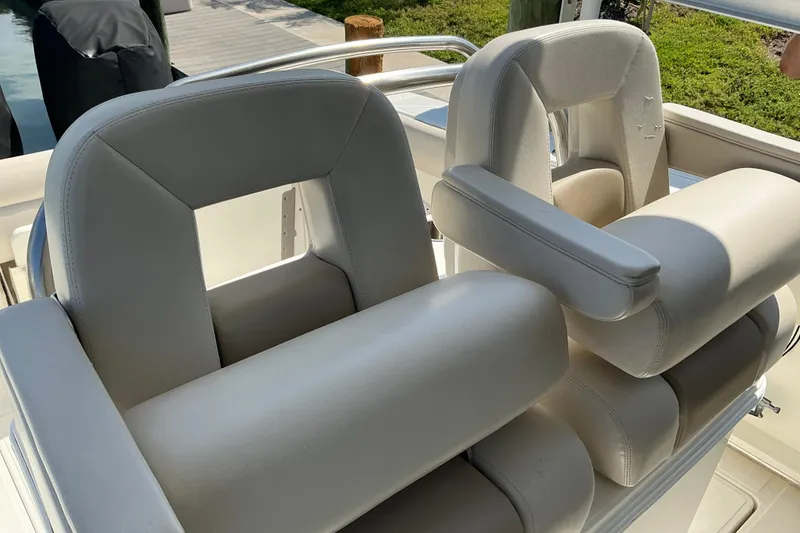Slide: The Image of 2017 Boston Whaler 250 Outrage boat seats with armrests in sunlight. - 40