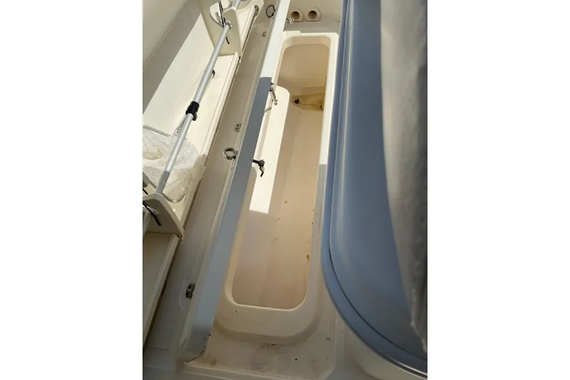 Slide: The Image of 2017 Boston Whaler 250 Outrage boat storage compartment with fishing rod holder. - 41