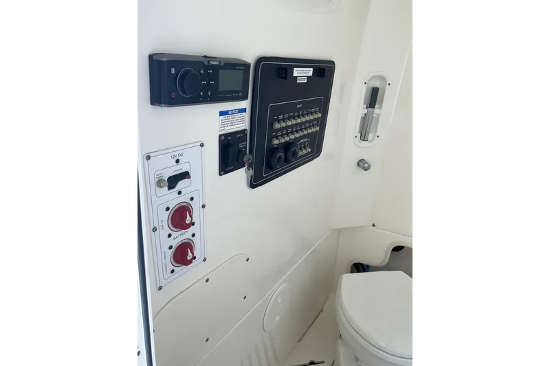Slide: The Image of Control panel and toilet area of a 2017 Boston Whaler 250 Outrage boat. - 44