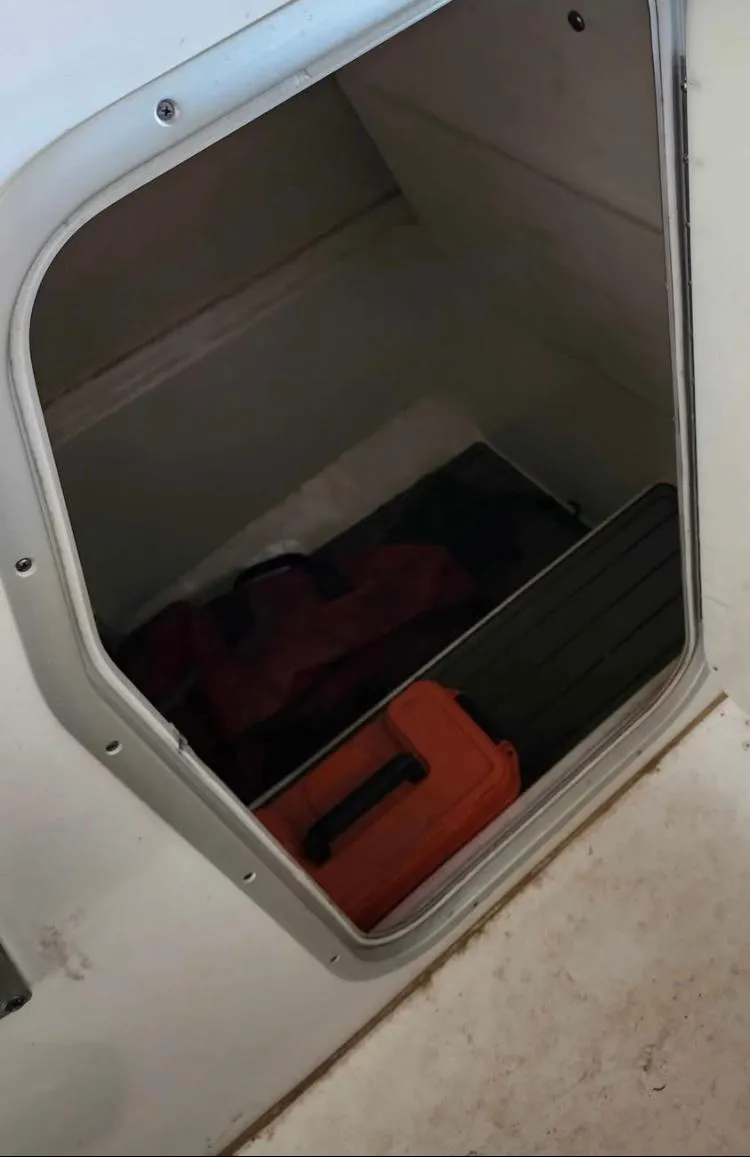 Slide: The Image of Storage compartment in 2020 Cape Horn 27 XS boat with equipment inside. - 9