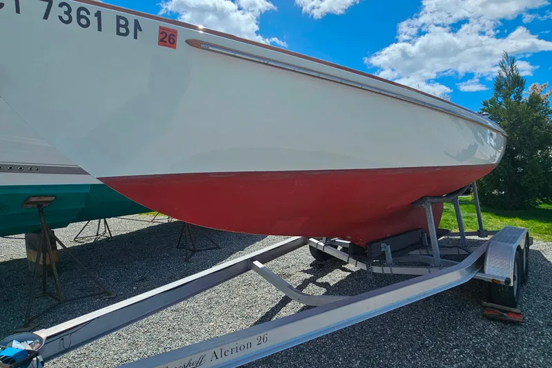 Slide: The Image of 2003 Herreshoff Alerion 26 sailboat on trailer under a bright blue sky. - 2