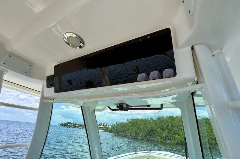 Slide: The Image of 2019 Boston Whaler 350 Outrage interior view with ocean and island backdrop. - 10