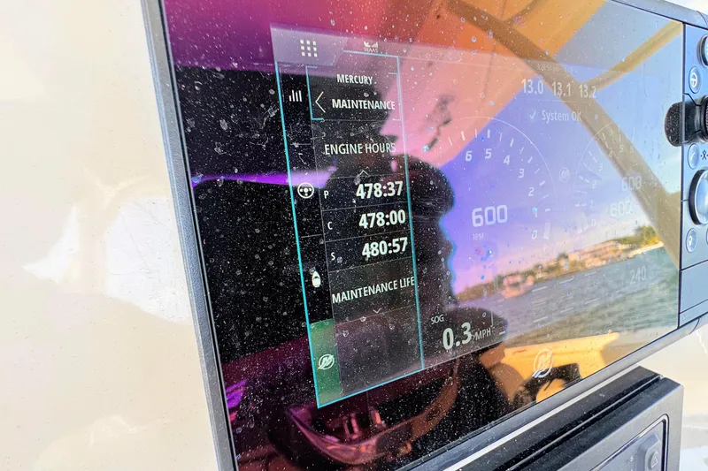 Slide: The Image of Close-up of a 2019 Boston Whaler 350 Outrage dashboard display showing engine hours. - 11