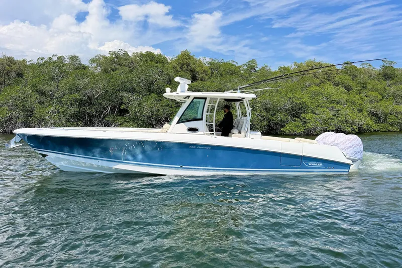 Slide: The Image of 2019 Boston Whaler 350 Outrage boat cruising on a scenic waterway. - 3
