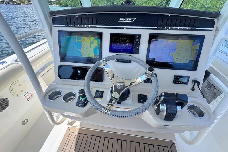 Slide: The Image of 2019 Boston Whaler 350 Outrage helm with advanced navigation displays and controls. - 8