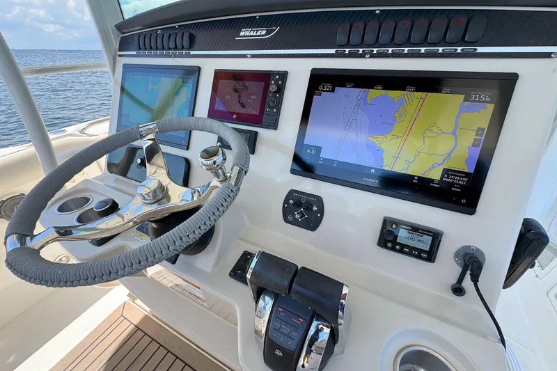 Slide: The Image of 2019 Boston Whaler 350 Outrage helm with advanced navigation displays and controls. - 9