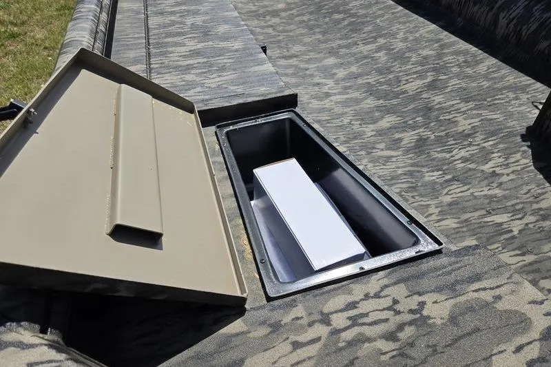 Slide: The Image of Open storage compartment in 2026 Havoc 1860 DBST boat, featuring camouflage design. - 13