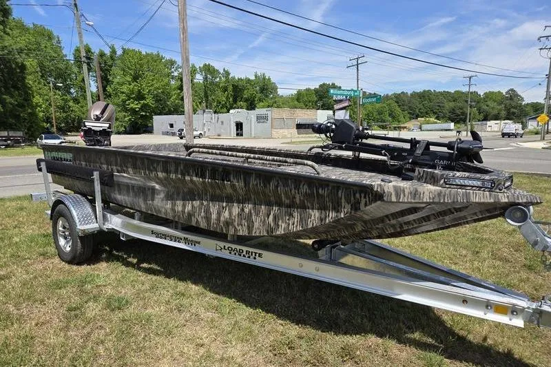 Slide: The Image of 2026 Havoc 1860 DBST boat on trailer, parked outdoors on grass. - 2