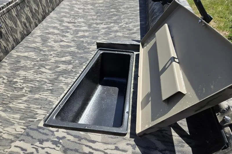 Slide: The Image of Open storage compartment on 2026 Havoc 1860 DBST boat with camouflage interior. - 9