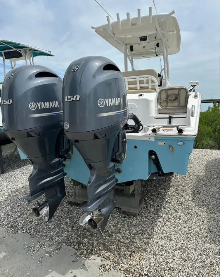 The Image of 2021 Sea Fox 268 Commander boat with dual Yamaha 150 engines, parked on gravel. - 0