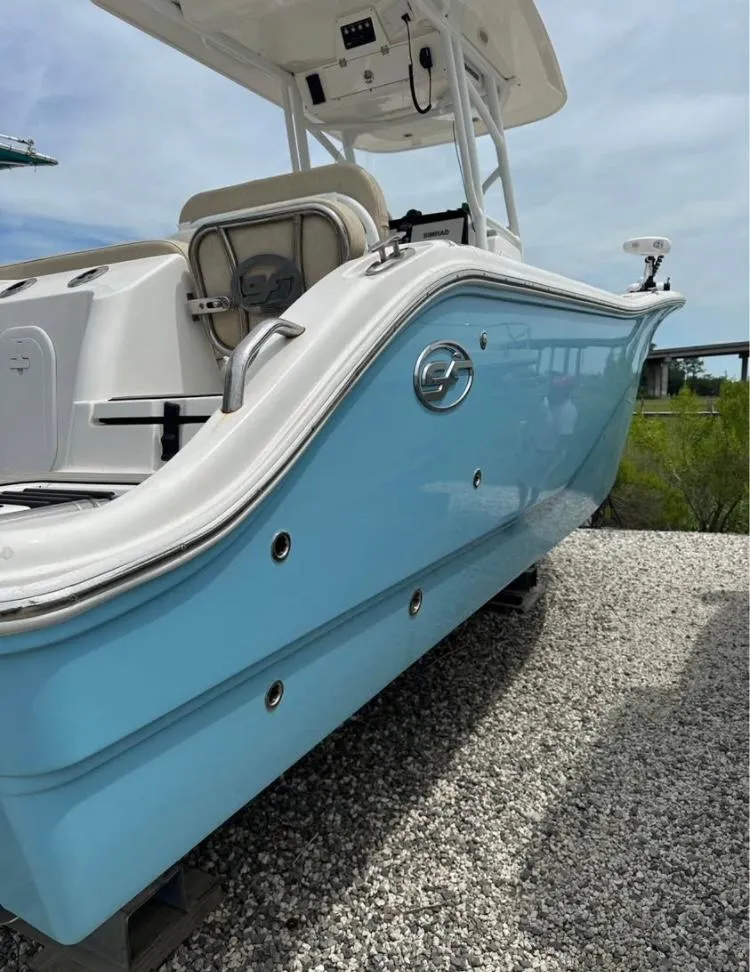 Slide: The Image of 2021 Sea Fox 268 Commander boat with light blue hull on gravel surface. - 2