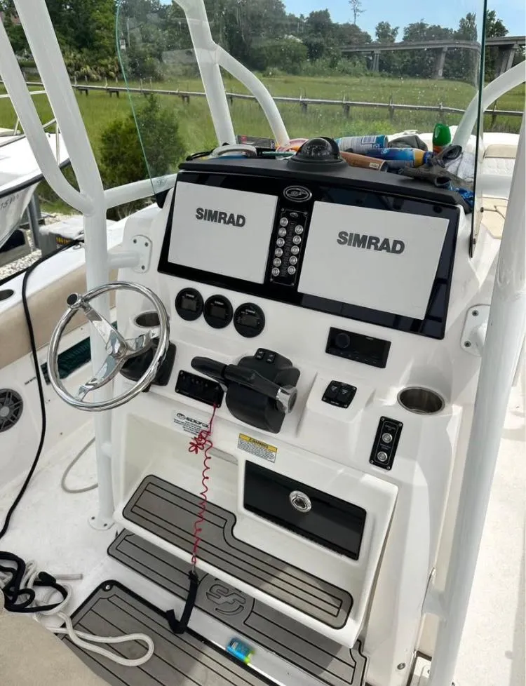 Slide: The Image of 2021 Sea Fox 268 Commander helm with dual Simrad displays and steering wheel. - 4