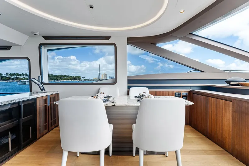 Slide: The Image of Luxurious interior of 2024 Aquitalia 78 Fly yacht with elegant dining area and scenic ocean view. - 13