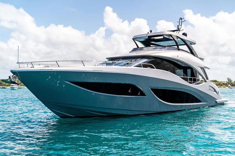 Slide: The Image of 2024 Aquitalia 78 Fly yacht cruising on clear blue water under a bright sky. - 4