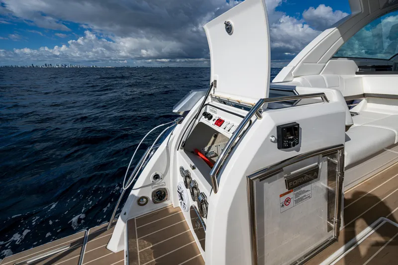 Slide: The Image of 2022 Formula 380 Super Sport Crossover OB on open sea with open control panel. - 18