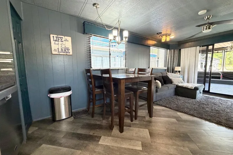 Slide: The Image of Interior of 1989 Sumerset 14x62 houseboat with dining area and cozy seating. - 11