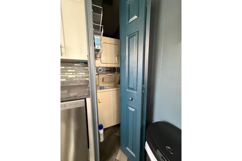 Slide: The Image of Compact laundry area in a 1989 Sumerset 14x62 houseboat with stacked washer and dryer. - 12