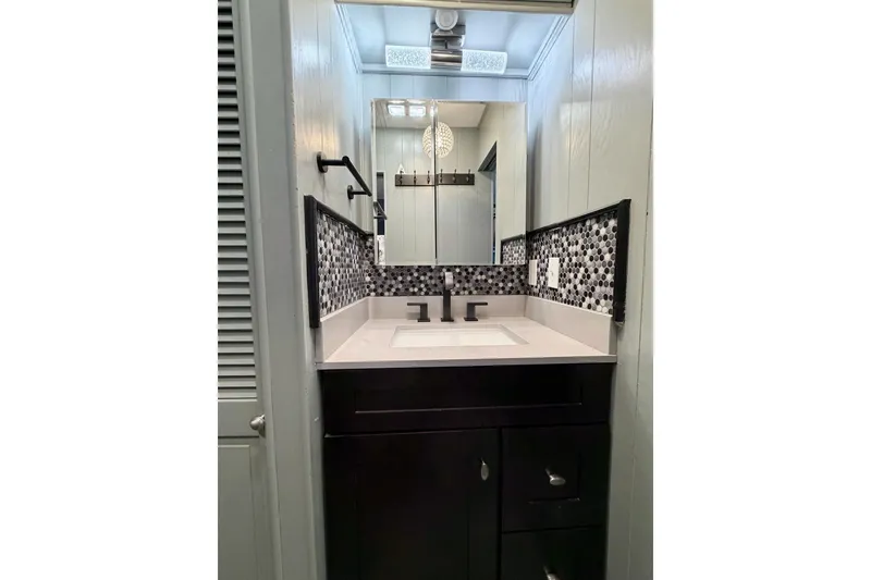 Slide: The Image of Modern bathroom vanity with mosaic backsplash in 1989 Sumerset 14x62 houseboat. - 16