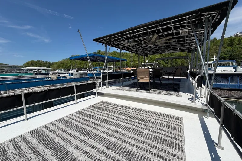 Slide: The Image of Houseboat deck with seating area, Sumerset 14x62, 1989 model, docked at marina. - 31